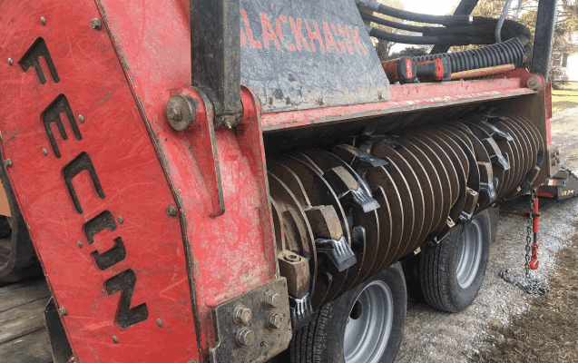 Forestry mulcher head clearing overgrown land
